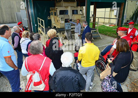 Joseph Gallegos, Training Specialist, Training Support Center Italy, shows the High Mobility Multipurpose Wheeled (HMMWV) Egress Assistance Trainer (HEAT) at the Delegation of Sovereign Military Order of Malta, during the visit at caserma Ederle, 22 Sept. 2016, Vicenza, Italy. The Sovereign Military Order of Malta (SMOM) or Order of Malta, is a Roman Catholic  Religious Order traditionally of military, chivalrous and noble nature for defense of Catholic faith and assistance to the poor. (U.S. Army photo by Visual Information Specialist Paolo Bovo/Released)