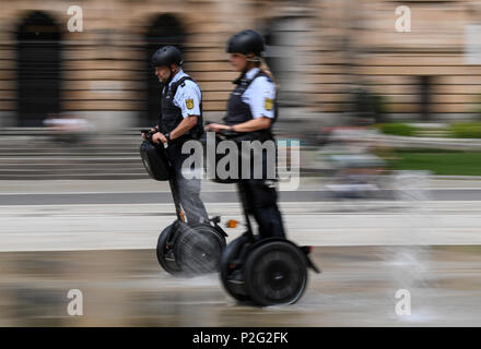 15 June 2018, Germany, Freiburg: Police officers Matthias Engler (L) and Janka Schmidt (R) standing on Segways in downtown Freiburg. The Police in Freiburg will be shortly deploying Segways on a permanent basis. A pilot test started 10 months ago was succesful. Photo: Patrick Seeger/dpa Credit: dpa picture alliance/Alamy Live News Stock Photo