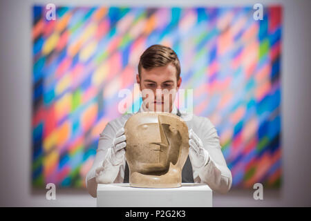 London, UK. 15th June 2018. Henry Moore, Head, circa 1934-36, estimate: £2,000,000-3,000,000 and Bridget Riley, Shadow Rhythm, est £500-800,000 - Christie’s Modern British Art Sale preview. The Modern British Art Evening Sale will take place on 19 June 2018 at Christie’s King Street. Credit: Guy Bell/Alamy Live News Stock Photo