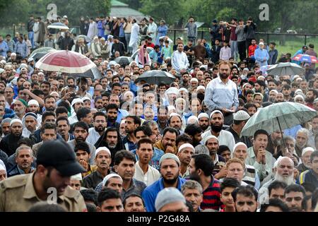 Srinagar, Kashmir. 15th June 2018. People gather to perform funeral prayer for Shujaat Bukhari, veteran journalist and Editor-in-Chief of English daily 'Rising Kashmir,' in Kreeri, some 45kms from Srinagar, Indian administered Kashmir. Thousands of mourners attended Shujaat Bukhari's funeral in Baramulla today. Bukhari and his personal security officers (PSO's) were shot dead by unidentified gunmen at Press Colony in Srinagar on Thursday evening. Credit: SOPA Images Limited/Alamy Live News Stock Photo