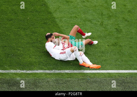 Saint Petersburg, Russia. 15th June, 2018. Iran's Alireza Jahanbakhsh and Morocco's Karim El Ahmadi lie on the ground during the FIFA World Cup 2018 Group B soccer match between Iran and Morocco at the Saint Petersburg Stadium, in Saint Petersburg, Russia, 15 June 2018. Credit: Saeid Zareian/dpa/Alamy Live News Stock Photo