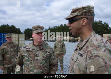 Lt. Col. Johnny A. Evans Jr., commander of the 3rd Battalion, 69th Armor Regiment, talks to Maj. Gen. Duane Gamble, commander of the 21st Theatre Sustainment Command, about the EAS (European Activity Set) turn in at Camp Adazi, Latvia, September 20, 2016. The EAS allows U.S. rotational forces in the region to move more quickly and easily to participate in training and exercises without having to bring all of their own equipment with them. 3rd Bn., 69th Arm. Rgmt., was in the region participating in Atlantic Resolve, a U.S. led effort being conducted in Eastern Europe to demonstrate U.S. commit Stock Photo