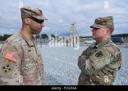 Lt. Col. Johnny A. Evans Jr., commander of the 3rd Battalion, 69th Armor Regiment, talks to Maj. Gen. Duane Gamble, commander of the 21st Theatre Sustainment Command, about EAS (European Activity Set) turn in at Camp Adazi, Latvia, September 20, 2016. The EAS allows U.S. rotational forces in the region to move more quickly and easily to participate in training and exercises without having to bring all of their own equipment with them. 3rd Bn., 69th Arm. Rgmt., was in the region participating in Atlantic Resolve, a U.S. led effort being conducted in Eastern Europe to demonstrate U.S. commitment Stock Photo