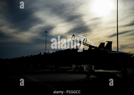 F-15E Strike Eagles assigned to the 494th Fighter Squadron from Royal Air Force Lakenheath, England, sit on the flightline after a day of flying in support of Tactical Leadership Programme 16-3 at Los Llanos Air Base, Spain Sep. 19. The training prepares NATO and allied forces’ flight leaders to be mission commanders, lead coalition force air strike packages, instruct allied flying and non-flying personnel in matters related to tactical composite air operations, and provide tactical air expertise to NATO agencies. (U.S. Air Force photo/ Staff Sgt. Emerson Nuñez) Stock Photo