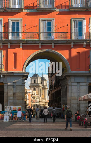 Madrid architecture city center, view south through the 17th century Arco Toledo in the Plaza Mayor towards the Iglesia Colegiata de San Isidro, Spain. Stock Photo