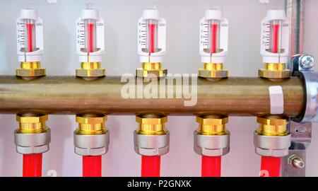 Water underfloor heating manifolds in system unit. Stock Photo