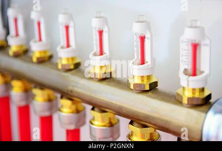 Water underfloor heating manifolds in system unit. Stock Photo