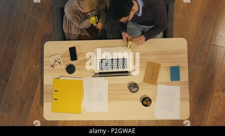 Workers enjoying lunch break in the office Stock Photo