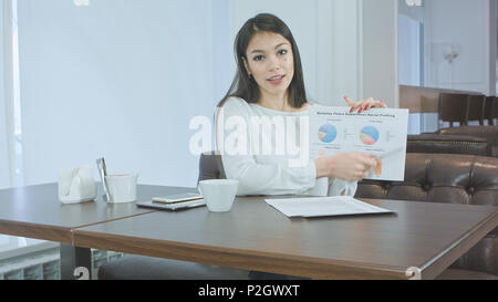 Attractive young woman giving business presentation in the cafe Stock Photo