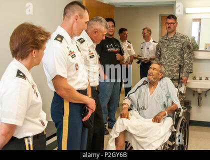 (From left) Brig. Gen. Diana M. Holland, Commandant of the U.S. Corps of Cadets, Command Sgt. Maj.  Timothy A. Guden, Command Sergeant Major of the U.S. Military Academy, Lt. Gen. Robert L. Caslen, Jr., U.S. Military Academy Superintendent, visit with Army veteran Robert Guzman, a patient at William Beaumont Army Medical Center, during a visit to WBAMC, Sept. 17. The visit allowed staff and cadets to interact with veterans and listen to stories of service and Army life. Stock Photo