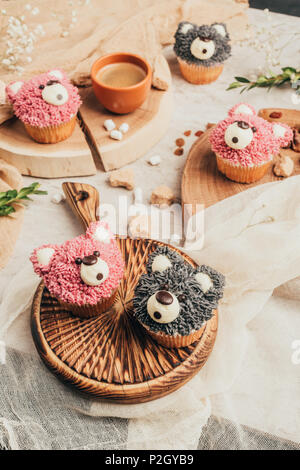 close-up view of delicious sweet cupcakes in shape of bears on table Stock Photo