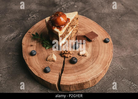 delicious piece of cake with chocolate and blueberries on wooden board Stock Photo