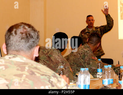 Sergeant training Ukrainian soldiers on a shooting range outdoor. Army ...