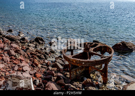 Old rusty wheel rotting away on seaside Stock Photo