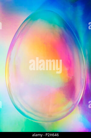 Colorful holographic egg shape in bright trendy neon style colors - abstract vaporwave background image suited to Easter celebrations and publicity Stock Photo