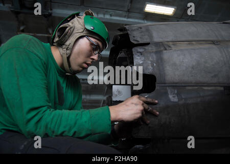 160925-N-QN175-009    ARABIAN GULF (Sep. 25, 2016) Aviation Machinist's Mate 3rd Class Ronald Gorman reassembles a variable exhaust nozzle following an inspection of an F/A-18E Super Hornet assigned to the Sidewinders of Strike Fighter Squadron (VFA) 86 in the hangar bay of the aircraft carrier USS Dwight D. Eisenhower (CVN 69) (Ike). Ike and its Carrier Strike Group are deployed in support of Operation Inherent Resolve, maritime security operations and theater security cooperation efforts in the U.S. 5th Fleet area of operations. (U.S. Navy photo by Mass Communication Specialist Seaman Dartez Stock Photo