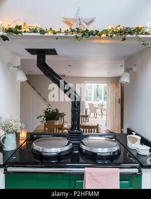 Green aga in contemporary cottage kitchen. The baen star is from Angel Stores and the tea towel from Susie Watson Designs. Stock Photo