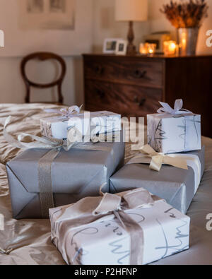 Detail of carefully wrapped gifts. Wrapping paper from The White Company Stock Photo