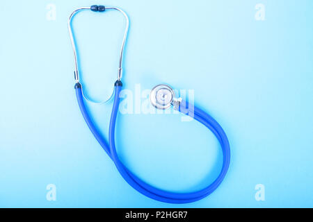 Medical blue stethoscope isolated on blue background. Stock Photo