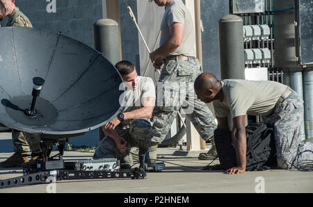 Senior Airman Carlos Menendez and Tech. Sgt. Lee Tillman, Joint Communication Support Element operators, set up a satellite system during a training exercise on MacDill Air Force Base, Fla. The JCSE's core mission it to provide premier communications, anywhere across the planet. (U.S. Air Force photo/Master Sgt. Brian Ferguson) Stock Photo