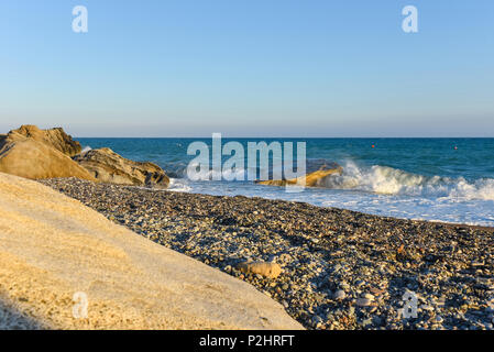 White waves crashing against a rocky beach Stock Photo