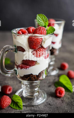 Delicious layered raspberry trifle in a glass jar Stock Photo