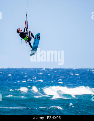 Kitesurfer in vertical ascent at the popular surfing beach of Playa del Medano on the coast of southern Tenerife Canary Islands Stock Photo