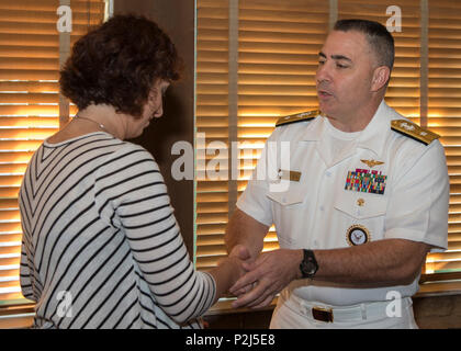 160929-N-KB426-137  SACRAMENTO, Calif. (Sept. 29, 2016) Rear Adm. Douglas 'Woody' Beal, deputy commander of Navy Recruiting Command and flag host of Sacramento Navy Week, presents Alex Telaro, president of the Kiwanis Club of Greater Sacramento, with a challenge coin during a presentation. Navy Weeks focus a variety of assets, equipment and personnel on a single city for a week-long series of engagements designed to bring America's Navy closer to the people it protects, in cities that do not have a large naval presence. (U.S. Navy photo by Petty Officer 3rd Class James Vazquez/Released) Stock Photo