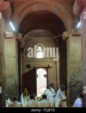 Men pray inside a rock-cut church in Lalibela. Stock Photo