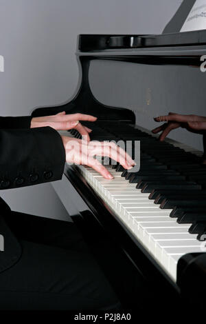 young woman playing the grand piano Stock Photo