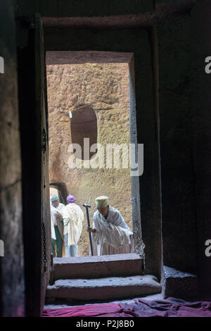 An elderly man enters a rock-cut church in Lalibela. Stock Photo