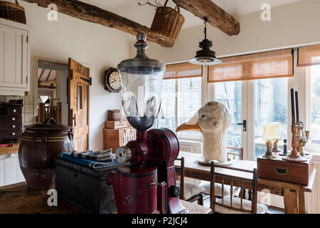 American 1920’s coffee grinder and large goose head in kitchen of Sussex barn conversion Stock Photo