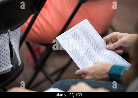 A spectator holds a list containing names of fallen fireman during the 15th annual Fire Department of New York (FDNY) Memorial Ceremony, New York City, N.Y., Sept. 11, 2016. Once a year, local, national, and international law enforcement, first responders, fire departments, and military bands host a parade and ceremony at the Fireman's memorial and Station 10. The ceremony serves to honor and remember the sacrifice of the local and national public officials that lost their lives during the attacks on Sept. 11, 2001, and unite those that rendered aid during the recovery. (U.S. Marine Corps phot Stock Photo