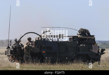A British soldier assigned to 1st The Queen's Dragoon Guards, Battle Group Poland dismounts from a Mobility Weapon-Mounted Installation Kit 'Jackal' during Saber Strike 18 at Bemowo Piskie Training Area, Poland on June 9, 2018. Saber Strike 18 is the eighth iteration of the long-standing U.S. Army Europe-led cooperative exercise designed to enhance interoperability among allies and regional partners. (Michigan Army National Guard photo by Spc. Steven Selis/released) Stock Photo