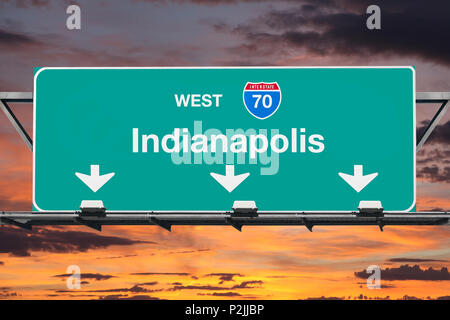 Indianapolis Indiana route 70 west overhead freeway sign with sunset sky. Stock Photo