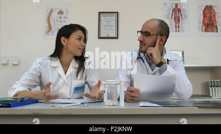 Two medical workers chatting causally while having break Stock Photo