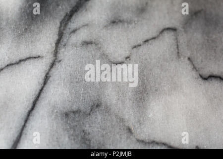 cloudy white and grey marble with black veins macro detail shot Stock Photo