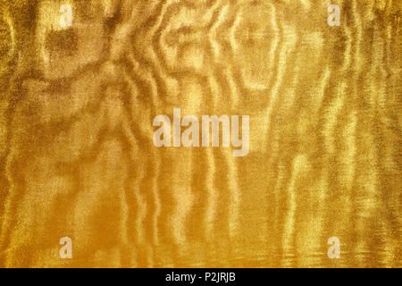 Gold textile texture with interference. Backdrop for creative projects. Stock Photo