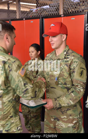 Private Frist Class Clayton Reynolds, a parachute rigger assigned to Group Support Battalion 3rd Special Forces Group (Airborne), received the Army Acheivment Medal on 07 Sep, 2016 at Fort Bragg, North Carolina.  When word of an active shooter spread through the Crabtree Valley Mall in Raleigh, North Carolina on 13 Aug, 2016, PFC Reynolds and another soldier assissted patrons of the mall who were knocked down as people raced towards the exits. Stock Photo