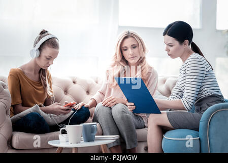 Professional psychologist showing test results to girls mother Stock Photo