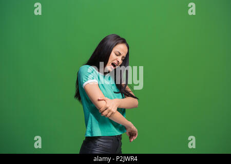 Young woman overwhelmed with a pain in the elbow Stock Photo