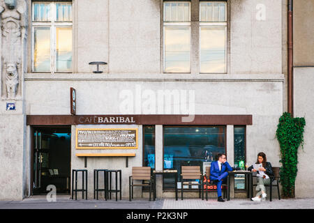 Prague, September 18, 2017: Street city cafe. A man with a woman at the table talking and ordering food. Stock Photo