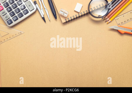 Overhead shot of school supplies on brown craft paper background Stock Photo