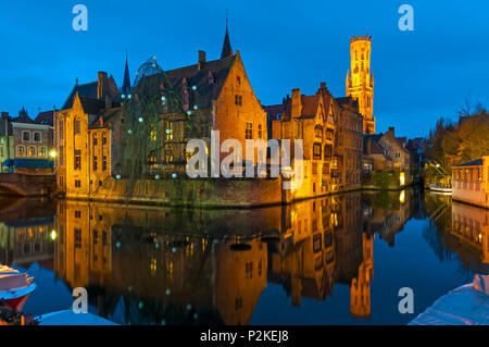 Cityscape of medieval Bruges with its canals and belfry during the blue hour, West Flanders, Belgium. Stock Photo