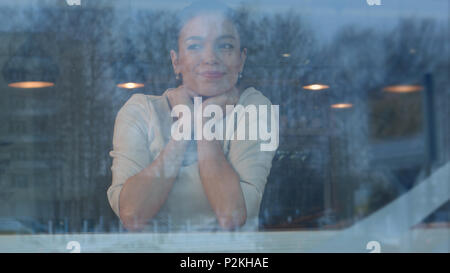 Young woman waiting in cafe for her order to be brought by the waiter Stock Photo