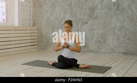 Woman doing Yoga at home - Marichyasana or Marichi's pose Stock Photo