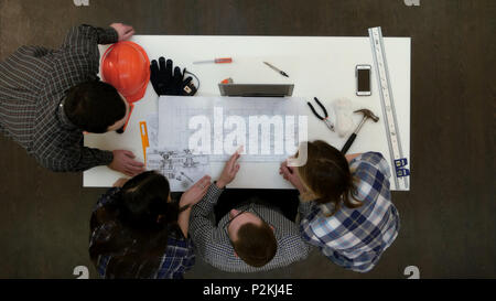 Group of young architects working on drawings Stock Photo
