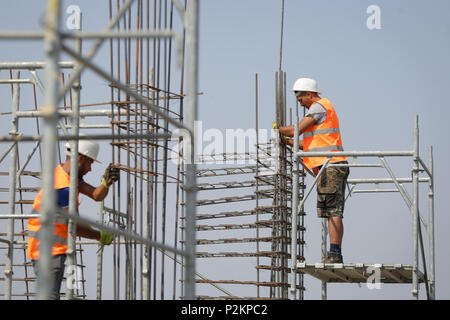 BUCHAREST, ROMANIA - JUNE 14, 2018: Workers on a construction site Stock Photo