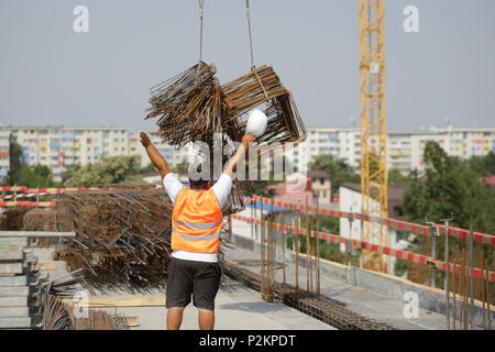 BUCHAREST, ROMANIA - JUNE 14, 2018: Workers on a construction site Stock Photo