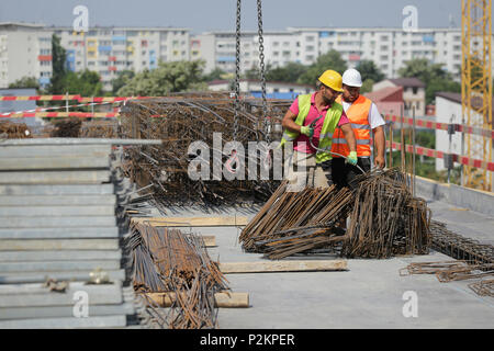 BUCHAREST, ROMANIA - JUNE 14, 2018: Workers on a construction site Stock Photo